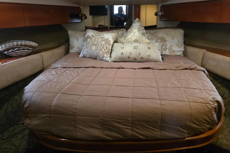  Yacht Photos Pics Luxurious bedroom interior of 1999 Viking Princess 56 yacht with elegant bedding.