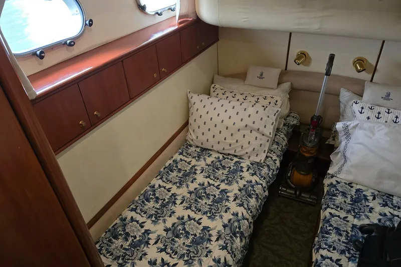  Yacht Photos Pics Cozy cabin interior of 1999 Viking Princess 56 yacht with twin beds and floral bedding.