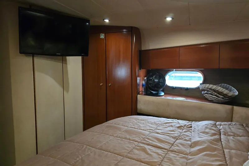  Yacht Photos Pics Cozy cabin interior of 1999 Viking Princess 56 yacht with TV and window.