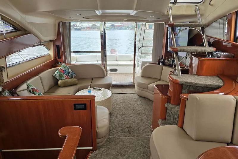  Yacht Photos Pics Luxurious 1999 Viking Princess 56 yacht interior with elegant seating and scenic water view.