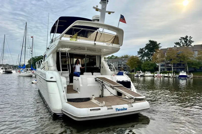  Yacht Photos Pics Luxury 1999 Viking Princess 56 yacht docked in a serene marina setting.
