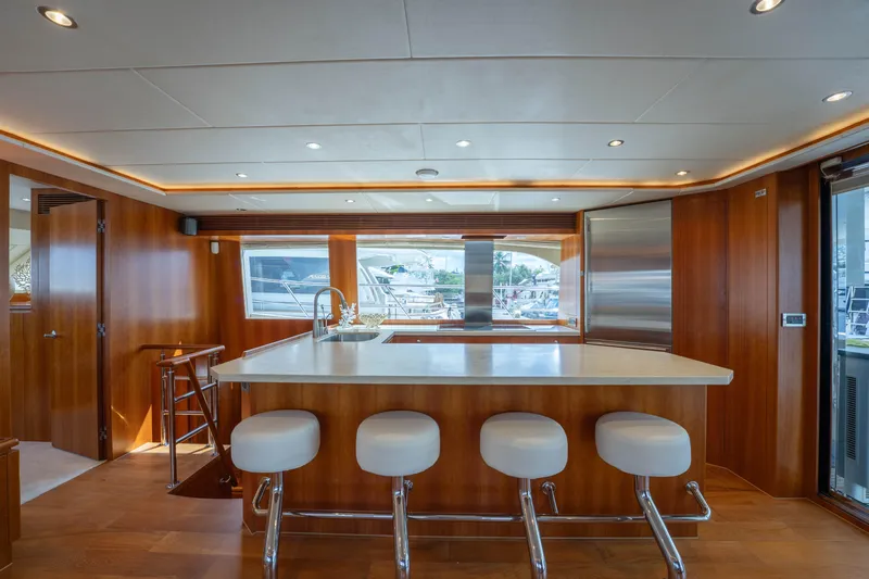 Vitality Yacht Photos Pics Luxurious 2016 Horizon PC60 yacht interior with modern kitchen and bar stools.