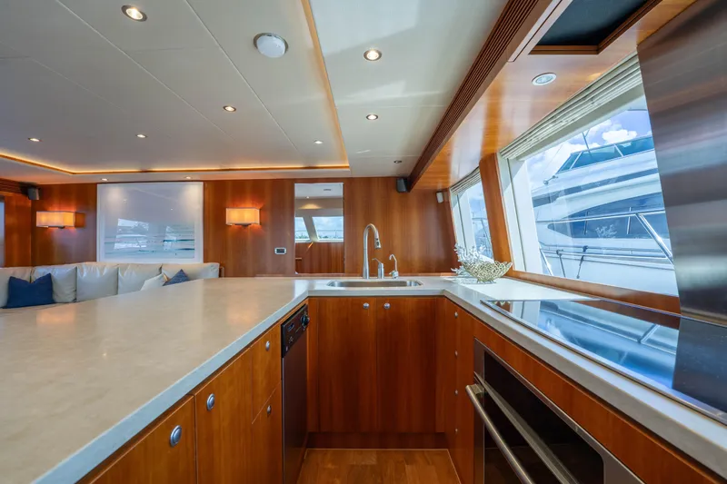 Vitality Yacht Photos Pics Luxurious 2016 Horizon PC60 yacht interior with modern kitchen and elegant wood finishes.