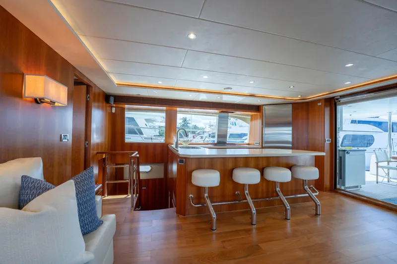 Vitality Yacht Photos Pics Luxurious interior of 2016 Horizon PC60 yacht with modern kitchen and seating area.