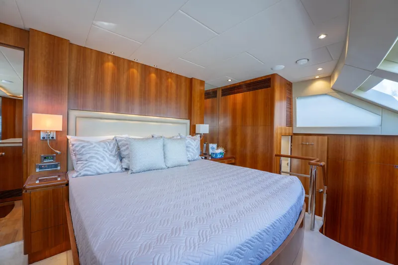 Vitality Yacht Photos Pics Luxurious bedroom interior on 2016 Horizon PC60 yacht with elegant wood paneling.