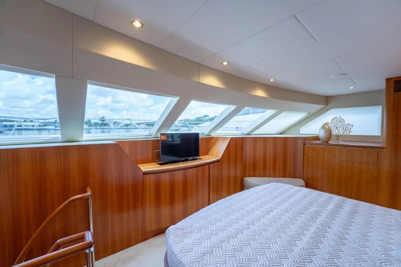 Vitality Yacht Photos Pics Luxurious 2016 Horizon PC60 yacht bedroom with panoramic windows and elegant wood paneling.