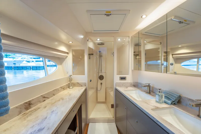Vitality Yacht Photos Pics Luxurious bathroom interior of 2016 Horizon PC60 yacht with dual sinks and shower.