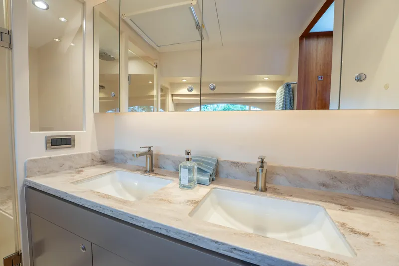 Vitality Yacht Photos Pics Luxurious Horizon PC60 2016 yacht bathroom with dual sinks and elegant fixtures.