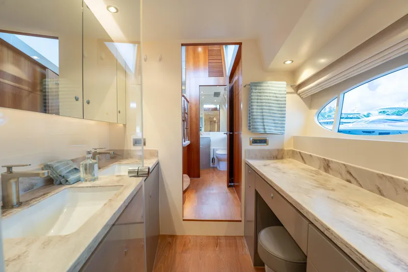 Vitality Yacht Photos Pics Luxurious bathroom interior on 2016 Horizon PC60 yacht, featuring marble countertops and modern fixtures.