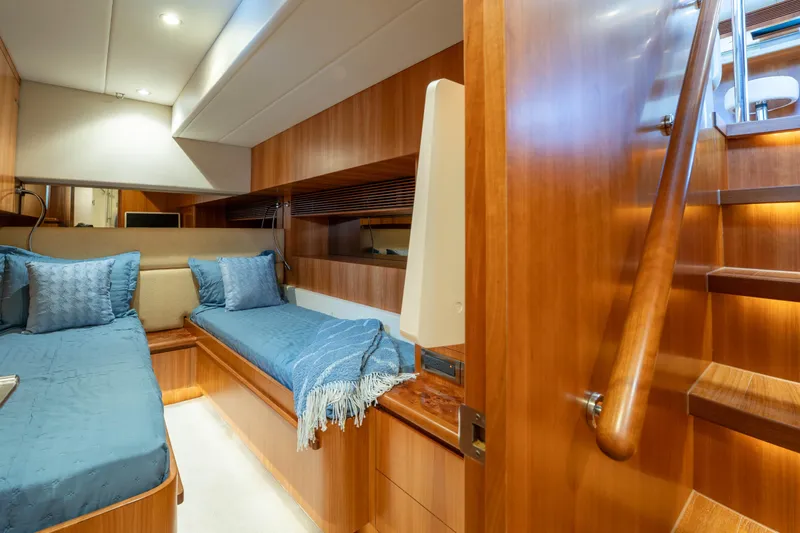 Vitality Yacht Photos Pics Luxurious 2016 Horizon PC60 yacht cabin with twin beds and wooden interior.