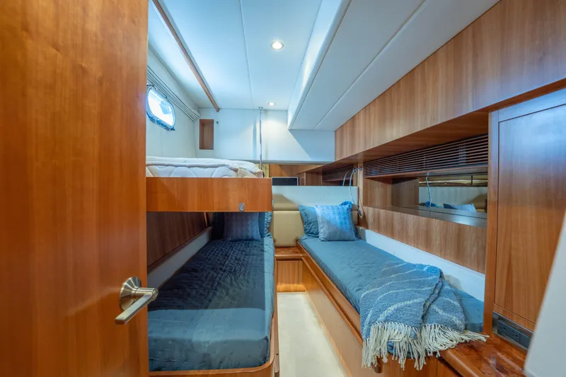 Vitality Yacht Photos Pics Luxurious 2016 Horizon PC60 yacht cabin with wooden interior and cozy bedding.