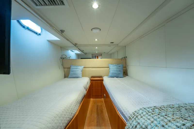 Vitality Yacht Photos Pics Interior of 2016 Horizon PC60 yacht cabin with twin beds and modern decor.