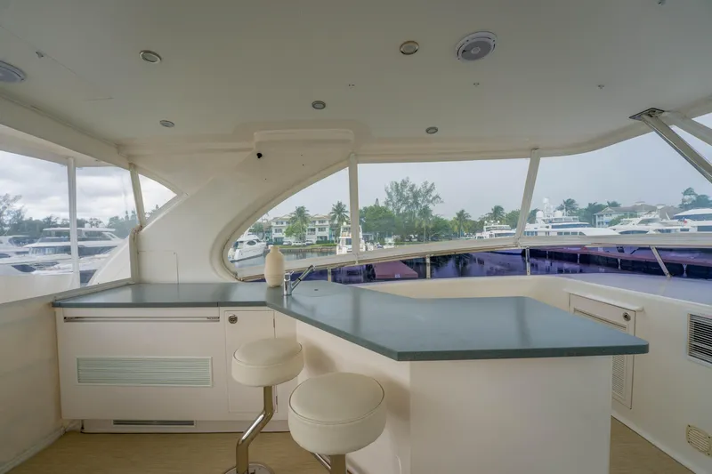 Vitality Yacht Photos Pics Luxurious 2016 Horizon PC60 yacht interior with modern bar and scenic marina view.