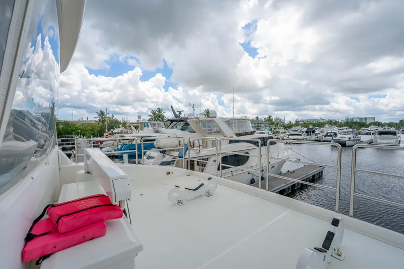 Vitality Yacht Photos Pics 2016 Horizon PC60 yacht docked at marina under cloudy sky.