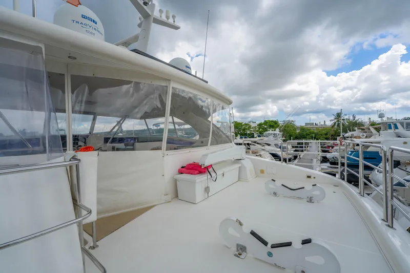 Vitality Yacht Photos Pics Luxury Horizon PC60 yacht deck, 2016 model, docked under cloudy skies.