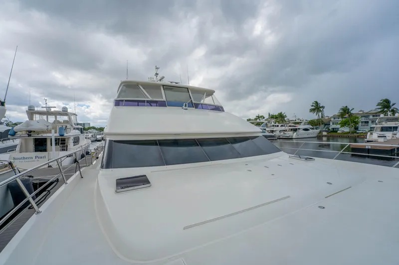 Vitality Yacht Photos Pics 2016 Horizon PC60 yacht docked at marina under cloudy skies.