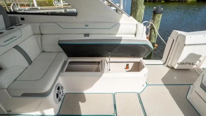  Yacht Photos Pics 2022 Regal LX36 boat interior with open storage compartments and cushioned seating.