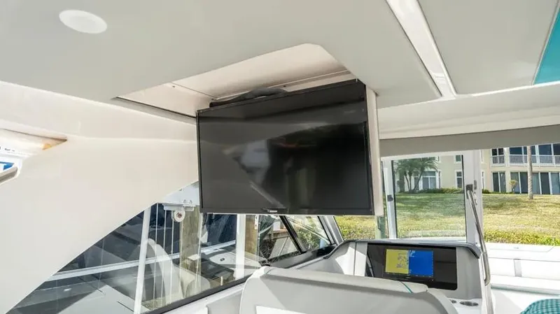  Yacht Photos Pics 2022 Regal LX36 interior with mounted TV and navigation system.