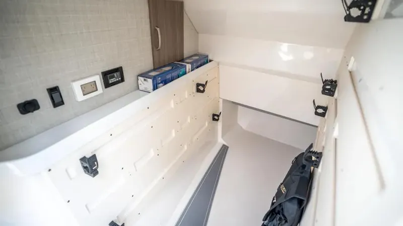  Yacht Photos Pics Interior cabin of 2022 Regal LX36 boat, featuring storage and control panels.
