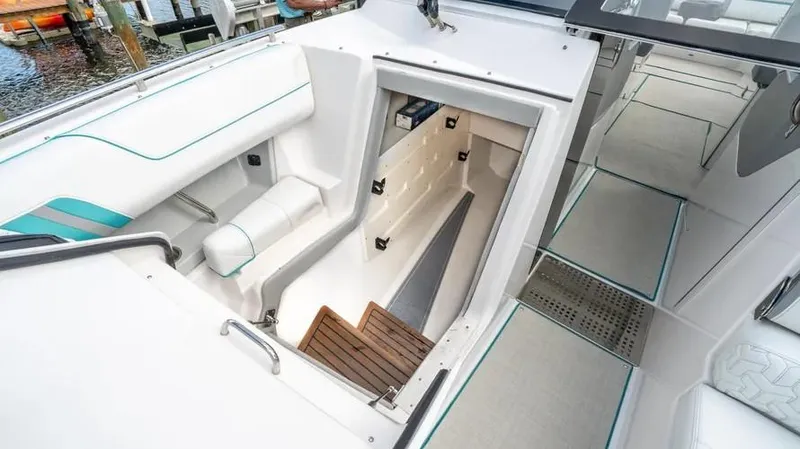  Yacht Photos Pics 2022 Regal LX36 boat interior with stairs leading below deck, featuring sleek white seating.