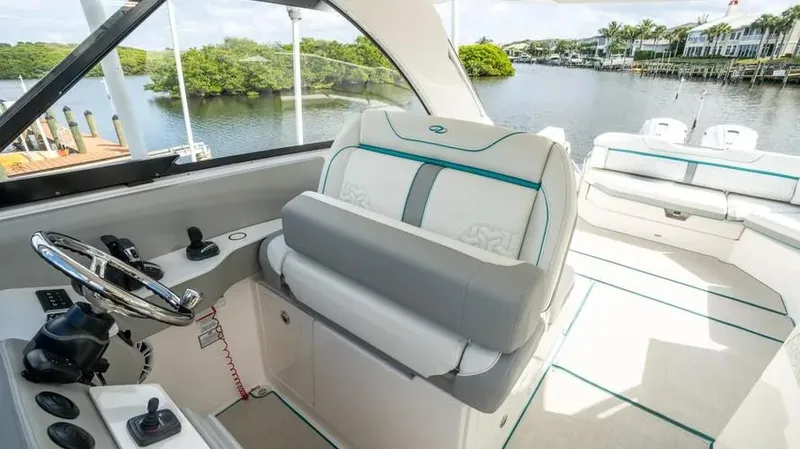  Yacht Photos Pics Luxurious 2022 Regal LX36 yacht interior with plush seating and scenic waterway view.