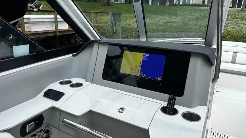 Yacht Photos Pics 2022 Regal LX36 boat dashboard with navigation screen and cup holders.