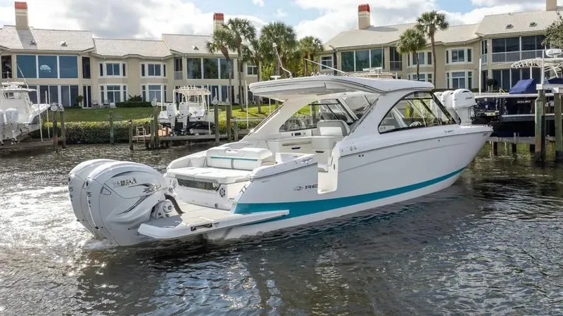  Yacht Photos Pics 2022 Regal LX36 boat docked near waterfront homes, showcasing sleek design and powerful engines.