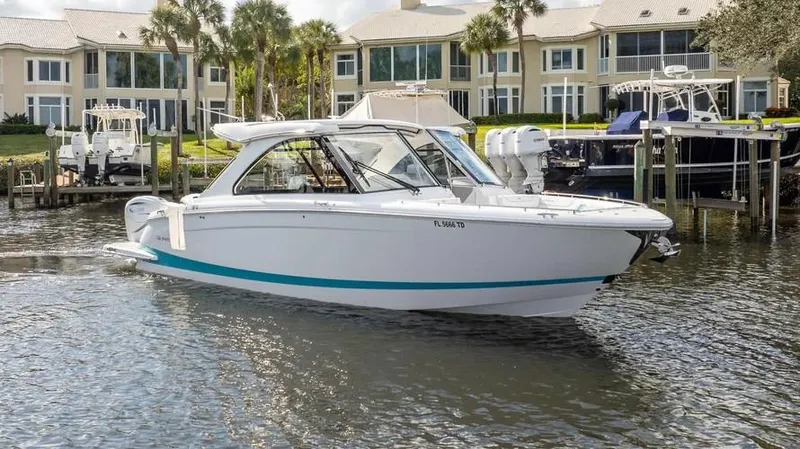  Yacht Photos Pics 2022 Regal LX36 boat docked near waterfront homes.