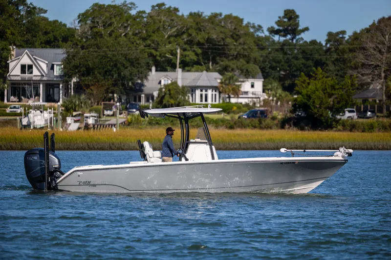  Yacht Photos Pics 2023 Pathfinder 2700 Open boat cruising on a scenic waterway near residential homes.