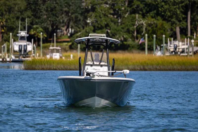  Yacht Photos Pics 2023 Pathfinder 2700 Open boat cruising on a serene waterway.