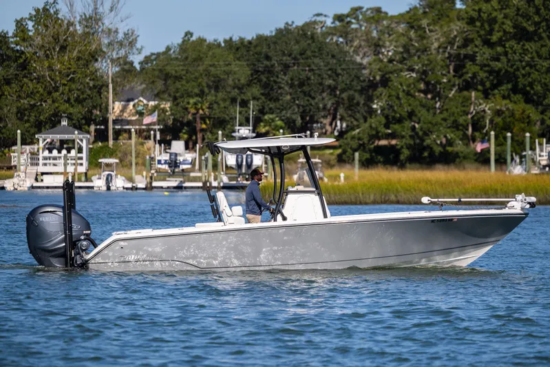  Yacht Photos Pics 2023 Pathfinder 2700 Open boat cruising on a scenic waterway with lush greenery.