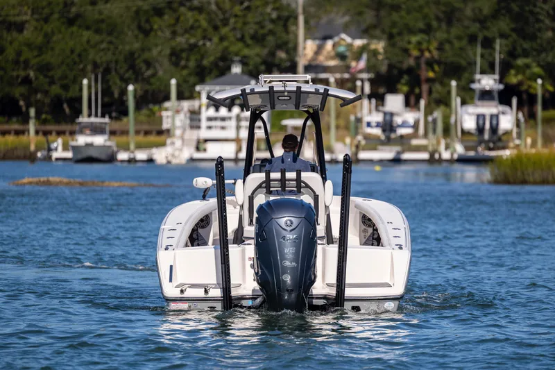  Yacht Photos Pics 2023 Pathfinder 2700 Open boat cruising on a calm waterway with scenic background.