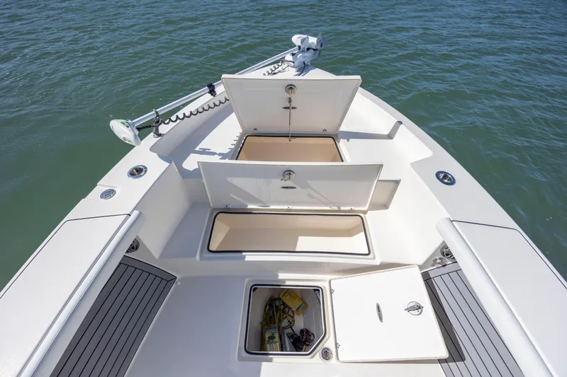  Yacht Photos Pics 2023 Pathfinder 2700 Open boat with open storage compartments on calm water.