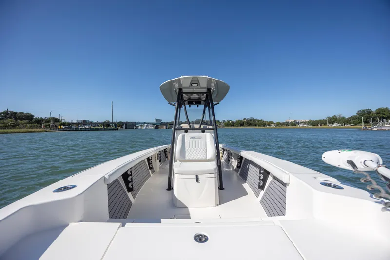  Yacht Photos Pics 2023 Pathfinder 2700 Open boat on calm water under clear blue sky.
