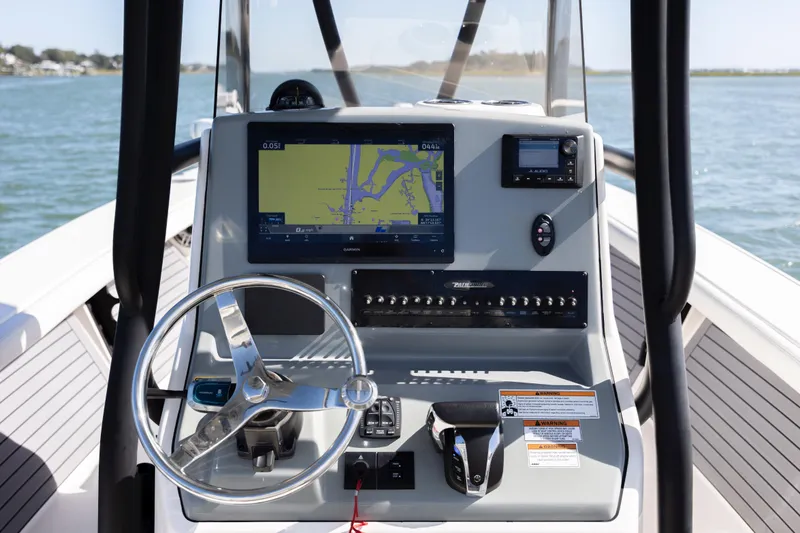  Yacht Photos Pics 2023 Pathfinder 2700 Open boat dashboard with navigation system and steering wheel.