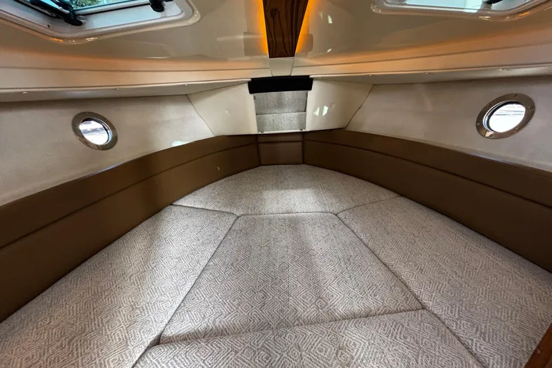  Yacht Photos Pics 2026 Ranger Tugs R-23 cabin interior with cozy seating and porthole windows.