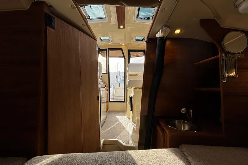  Yacht Photos Pics Interior of 2026 Ranger Tugs R-23 boat, featuring wood finishes and compact design.