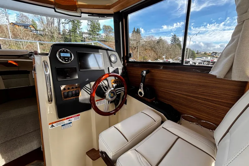  Yacht Photos Pics 2026 Ranger Tugs R-23 boat interior with steering wheel and control panel.