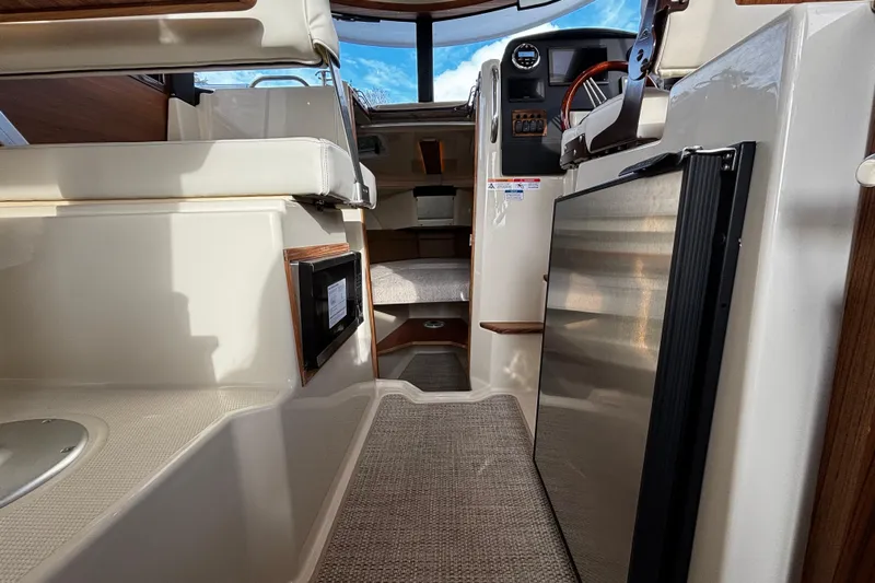  Yacht Photos Pics Interior view of 2026 Ranger Tugs R-23 boat, featuring seating and helm area.