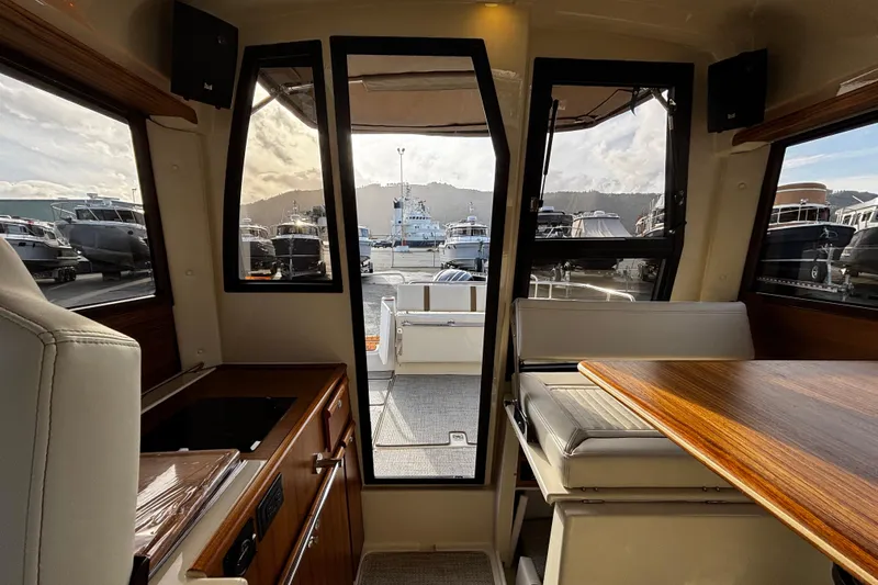  Yacht Photos Pics Interior view of 2026 Ranger Tugs R-23 boat, showcasing seating and windows.