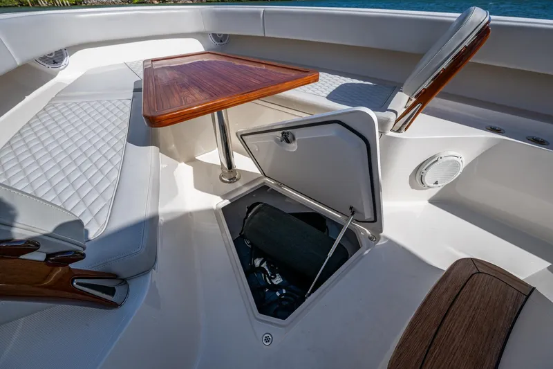 Seas The Day Yacht Photos Pics 2020 Jupiter 43 boat interior with seating, table, and storage compartment.