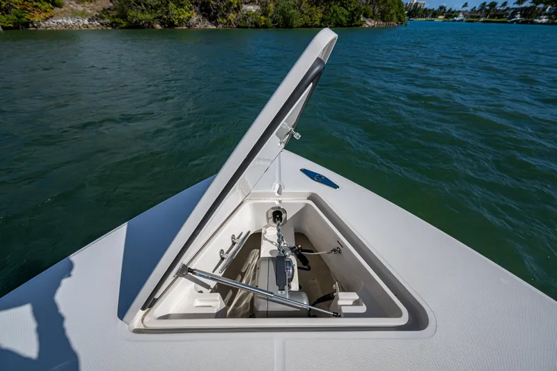 Seas The Day Yacht Photos Pics Open anchor hatch on 2020 Jupiter 43 boat, surrounded by water and greenery.
