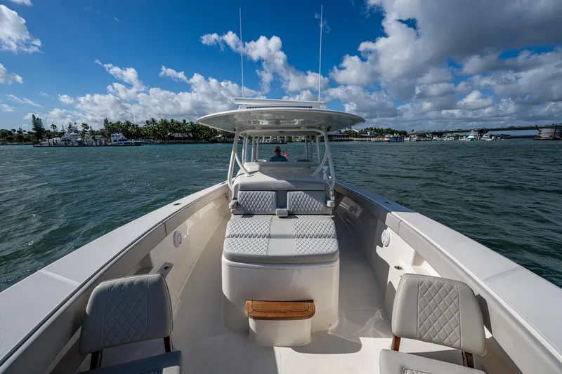 Seas The Day Yacht Photos Pics 2020 Jupiter 43 boat on water, featuring spacious seating and clear skies.