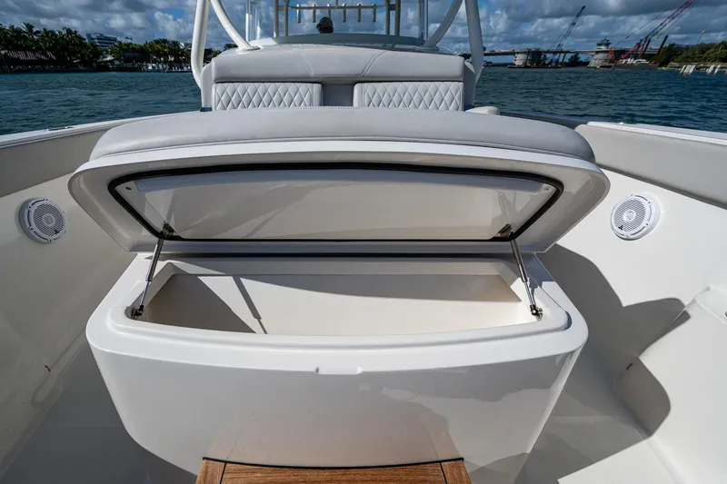 Seas The Day Yacht Photos Pics 2020 Jupiter 43 boat with open storage compartment, docked by the water.