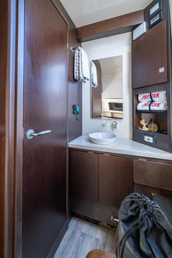 Seas The Day Yacht Photos Pics Luxurious bathroom interior in 2020 Jupiter 43 model yacht, featuring modern fixtures and elegant wood finishes.