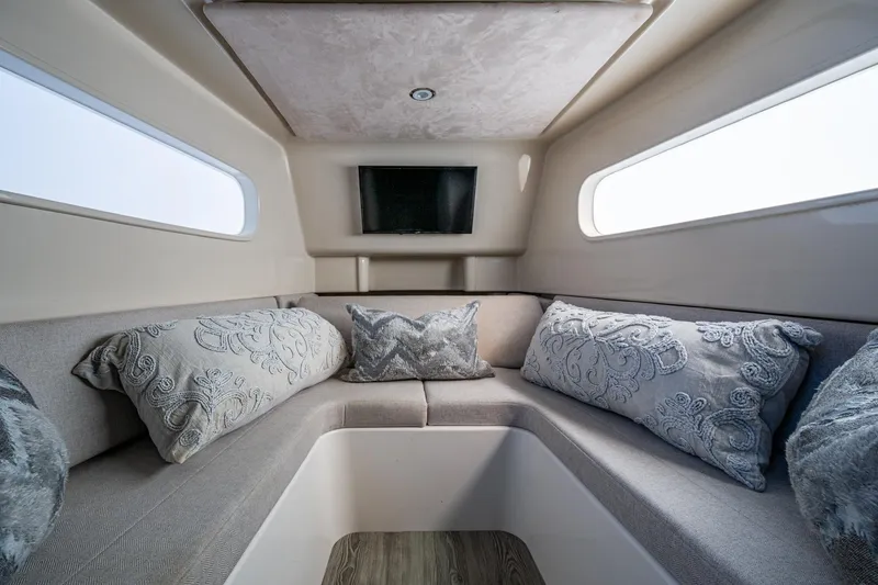 Seas The Day Yacht Photos Pics Luxurious interior of 2020 Jupiter 43 boat with elegant seating and decorative pillows.