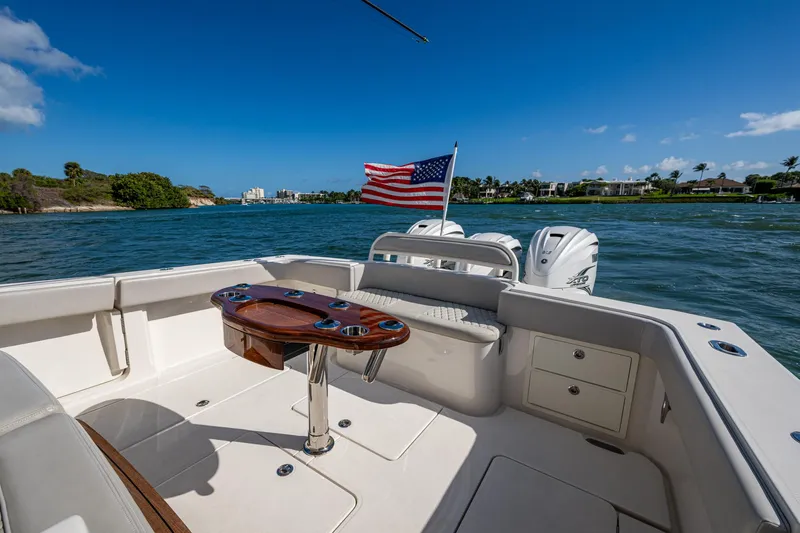 Seas The Day Yacht Photos Pics 2020 Jupiter 43 boat deck with American flag, scenic water view.