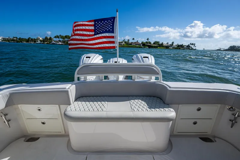 Seas The Day Yacht Photos Pics Jupiter 43 boat, 2020 model, with American flag on open water.
