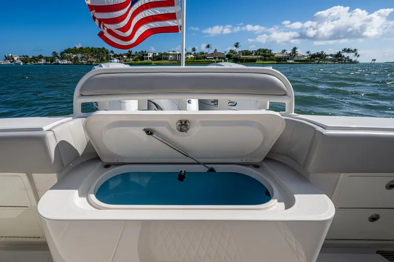 Seas The Day Yacht Photos Pics Open storage compartment on 2020 Jupiter 43 boat with American flag in background.