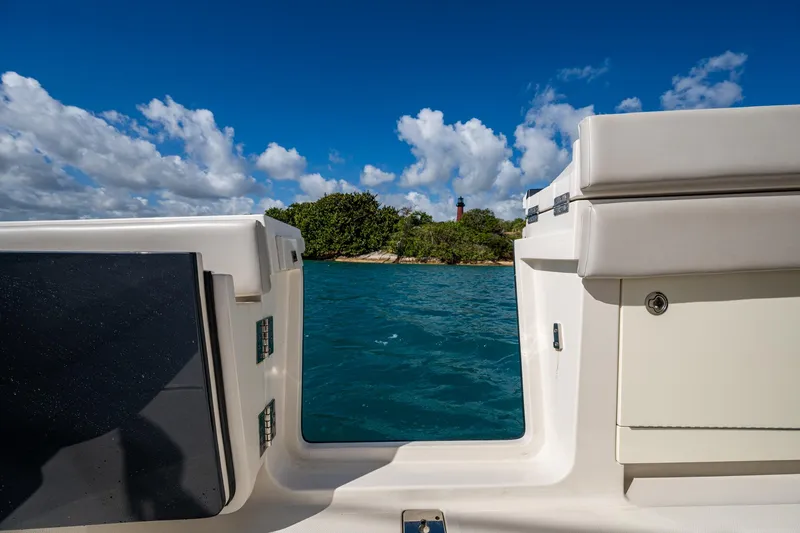Seas The Day Yacht Photos Pics View from a 2020 Jupiter 43 boat, overlooking blue water and lush island scenery.